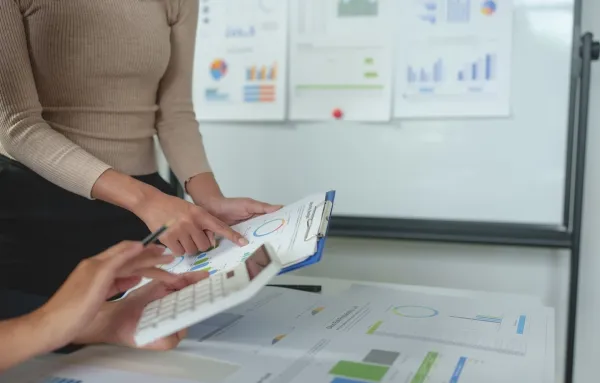 Personnes analysant des graphiques et des données financières lors d'une réunion